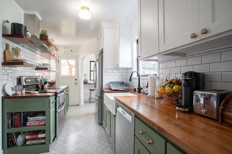 Small kitchen with green cabinets and wood countertops