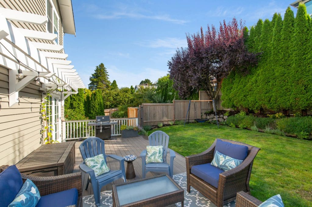 253829thAvenueWest_0024 Backyard deck with green lawn and blue patio chairs