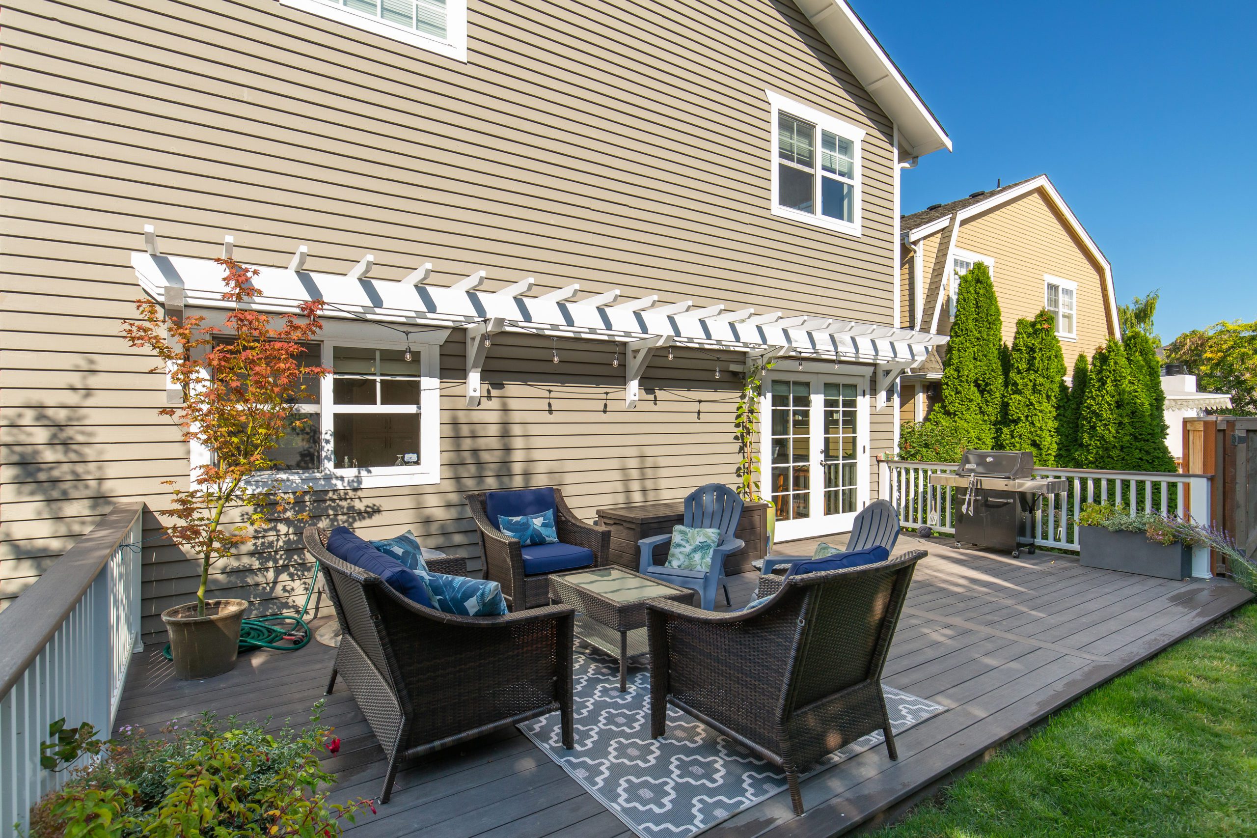 Backyard patio deck with chairs and BBQ