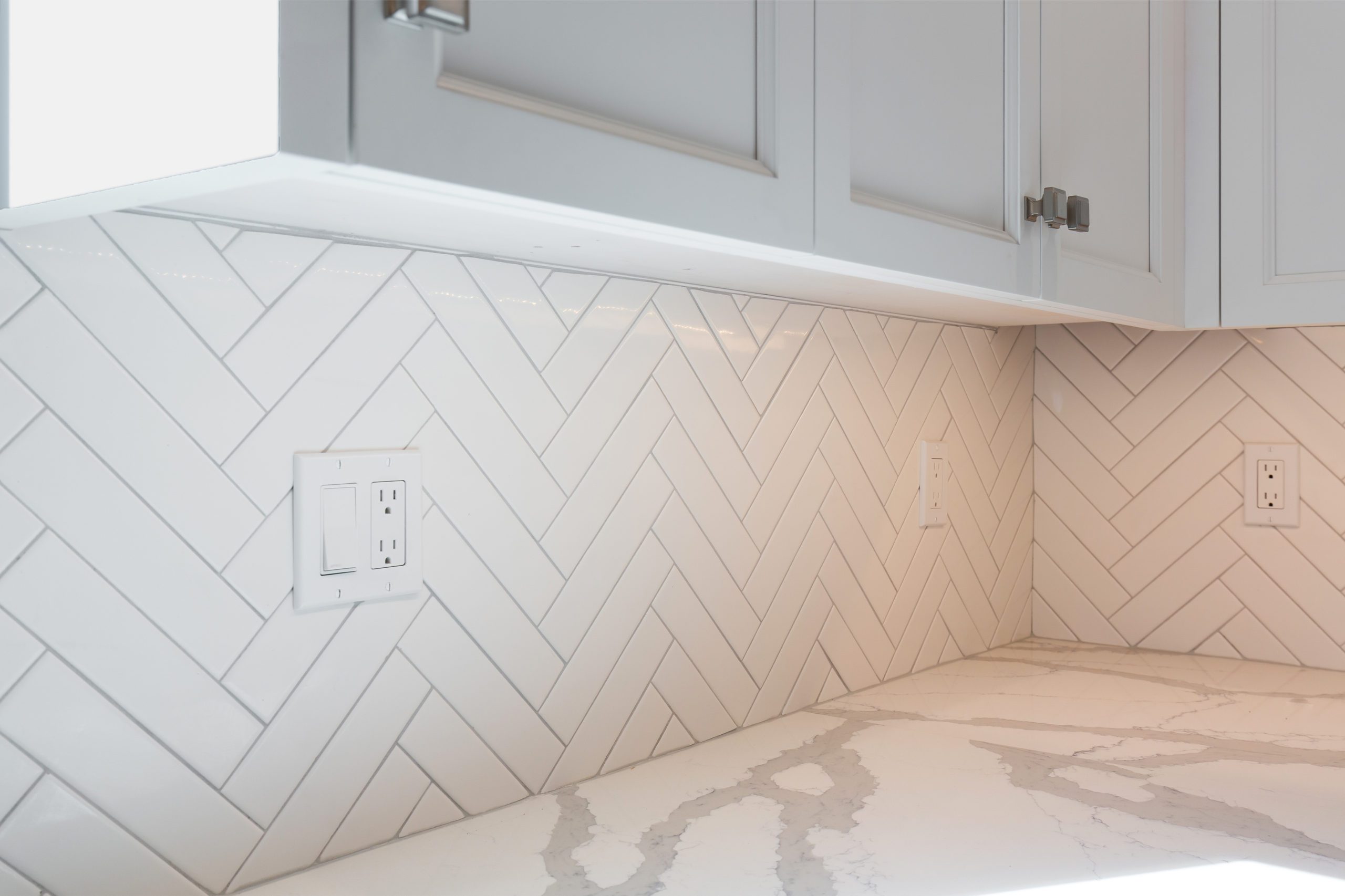 White chevron style backsplash kitchen tile