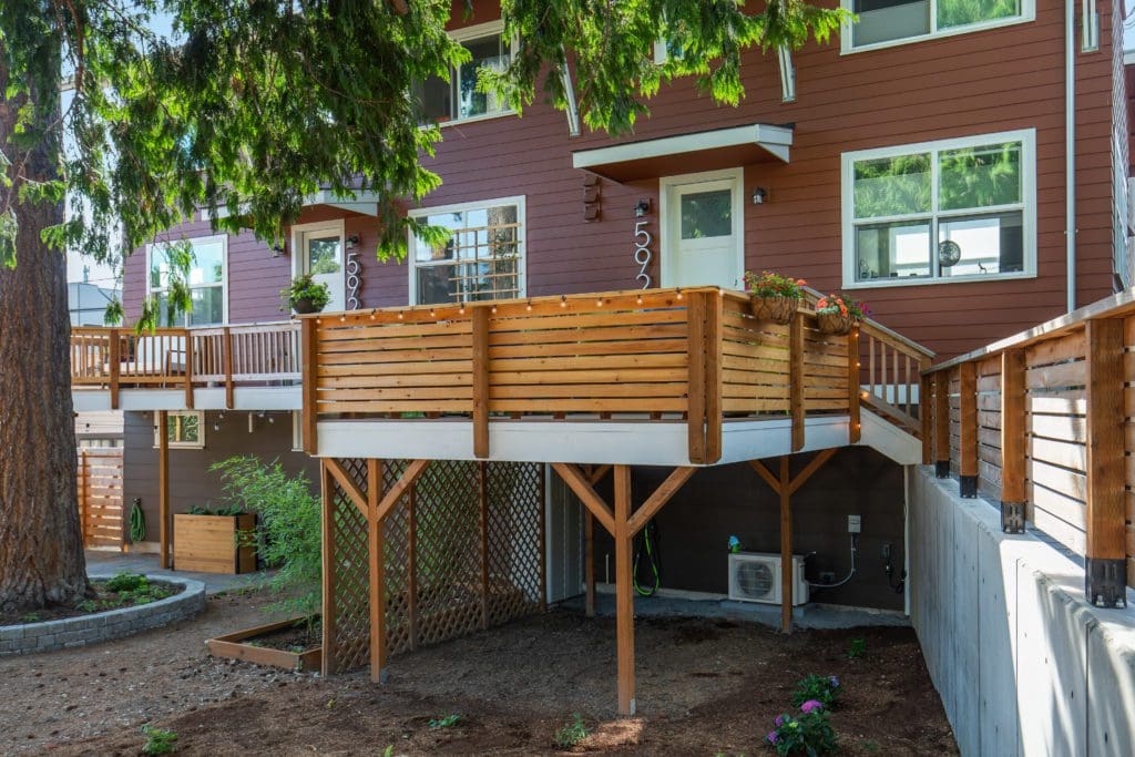 592342ndAvenueSouthwest_0013 Red house with raised wood deck and tree