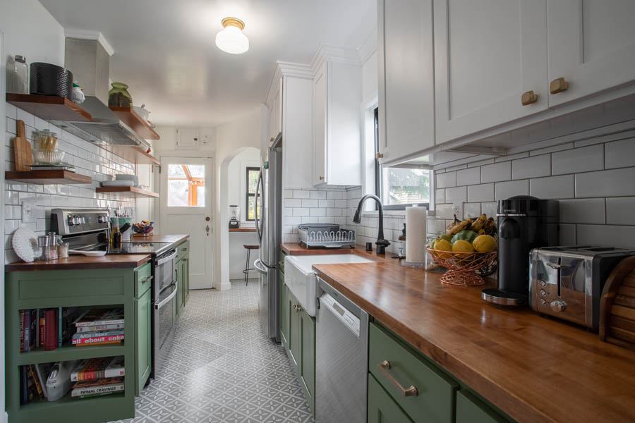 Kitchen remodel with green cabinets and wood counter top