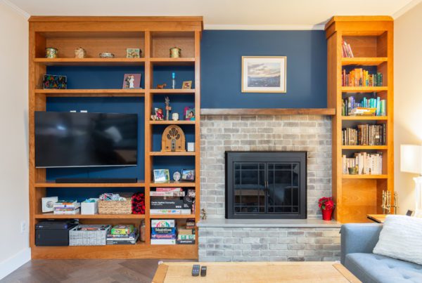 Remodeled wall alcove with a deep blue pain backsplash featuring wooden shelves