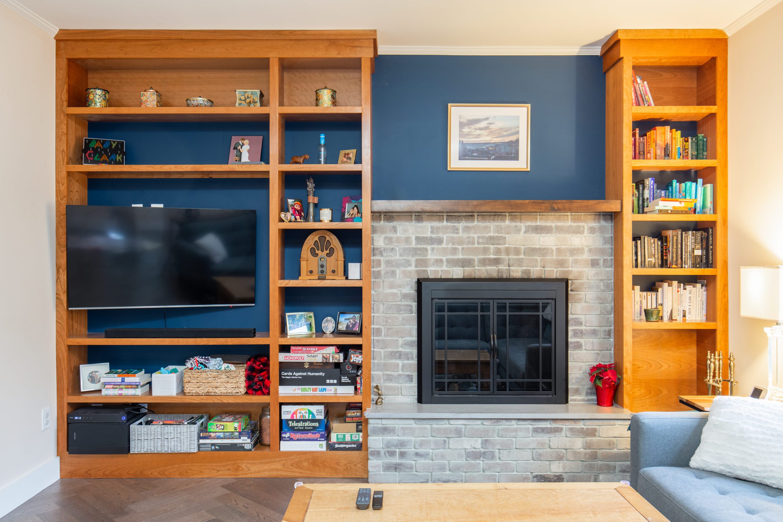 Remodeled wall alcove with a deep blue pain backsplash featuring wooden shelves