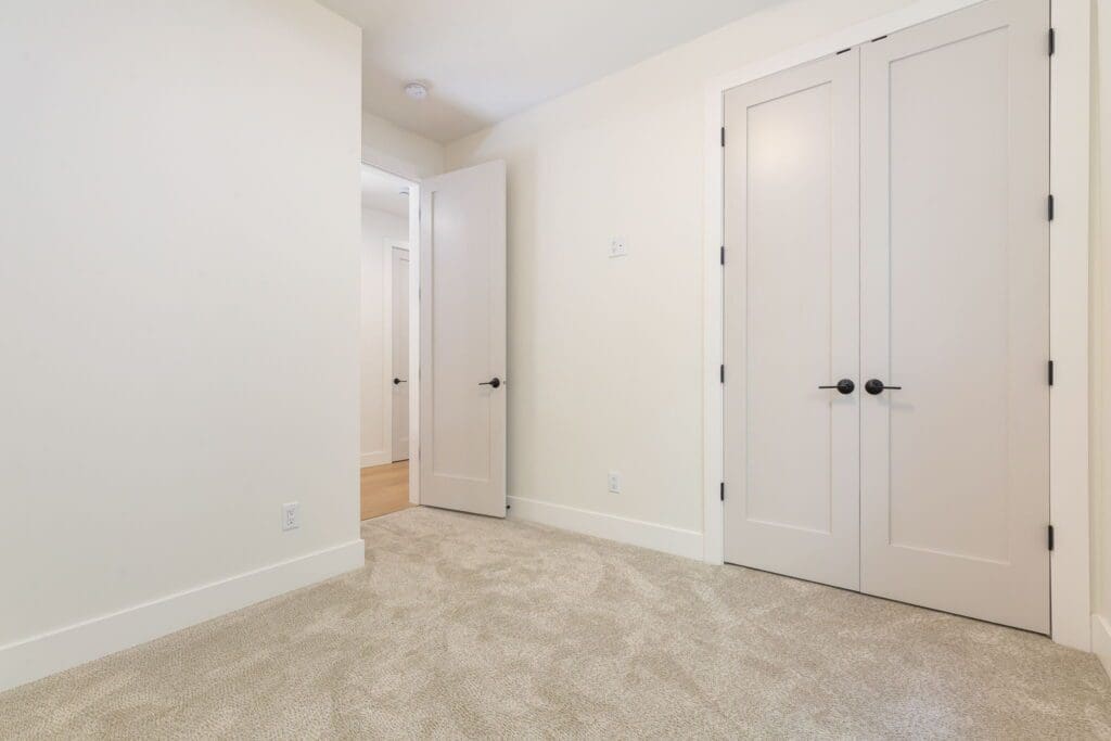 6733 46th Ave SW, Seattle WA_0034 Bedroom featuring closet with french doors in Seattle custom home build.