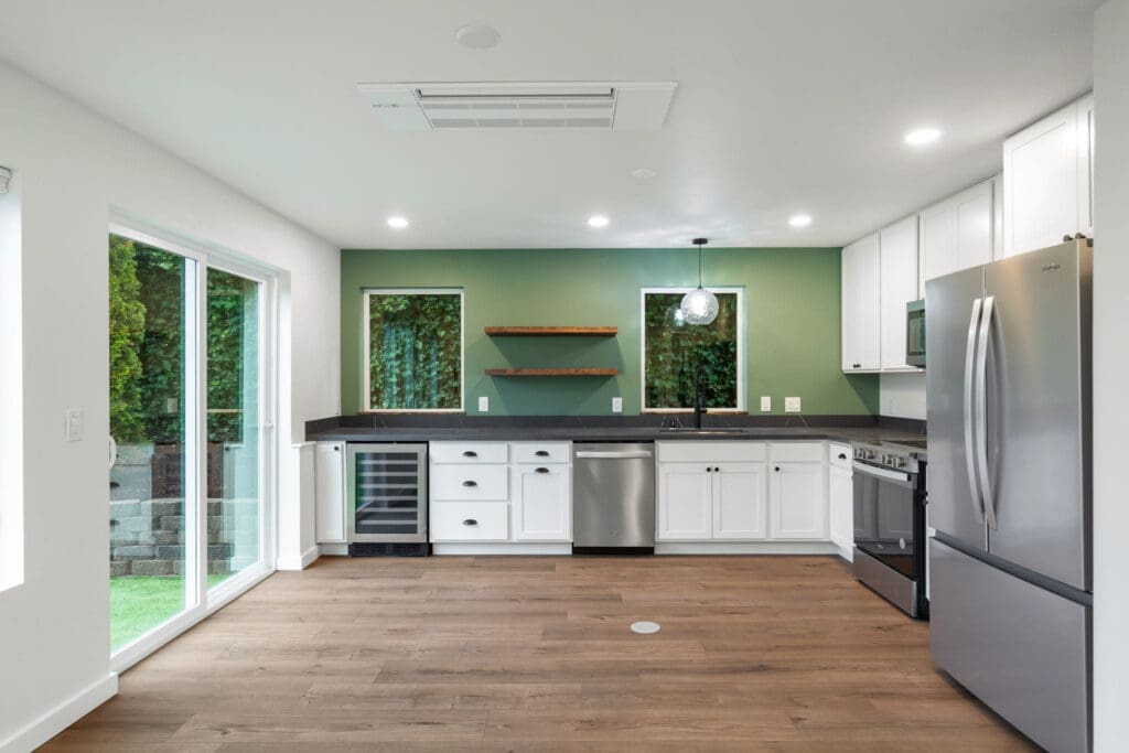 525 19th Ave, Seattle WA_0018 Kitchen with green walls and sliding glass doors in two-story, 1,000 sq ft Seattle DADU