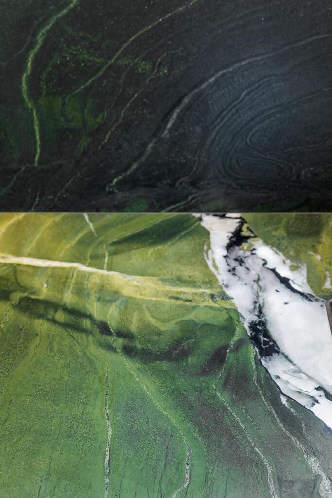 Custom Home Whiskey Bar 14 A close-up of green and black marble surfaces with white veining, showing natural patterns and textures—perfect for elevating the look of a custom home bar.